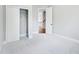 Bedroom featuring closet with sliding doors and a doorway leading to hallway with stairway at 203 S South Bend Dr, Durham, NC 27713