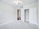 Bedroom showcasing a fan, neutral carpet and closet; open doorway adds depth at 203 S South Bend Dr, Durham, NC 27713