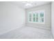 Bright bedroom with neutral carpet and paint, plus a window offering lots of natural light and views at 203 S South Bend Dr, Durham, NC 27713