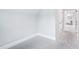 Small bedroom with neutral carpet and access to another room at 203 S South Bend Dr, Durham, NC 27713
