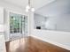 Dining area features hardwood floors, access to porch, and adjacent living area with fireplace at 203 S South Bend Dr, Durham, NC 27713