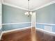 Traditional dining room with hardwood floors, blue walls, and white trim at 203 S South Bend Dr, Durham, NC 27713