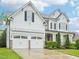 Craftsman style home featuring white siding, two car garage, manicured landscaping at 203 S South Bend Dr, Durham, NC 27713