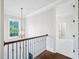 Second story hallway featuring wood floors, decorative chandelier, and view to a bedroom at 203 S South Bend Dr, Durham, NC 27713