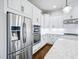Chef's kitchen features stainless steel appliances, white cabinets, granite countertops, and a center island at 203 S South Bend Dr, Durham, NC 27713