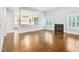 Bright living room with hardwood floors, a fireplace, and an open view to the kitchen at 203 S South Bend Dr, Durham, NC 27713