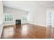 Spacious living room features hardwood flooring, fireplace, and bright windows with plantation shutters at 203 S South Bend Dr, Durham, NC 27713