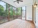 Screened in porch featuring a ceiling fan, wood deck and an open view to the treeline at 203 S South Bend Dr, Durham, NC 27713