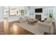 Staged living room with plush seating, fireplace, TV and views to the gourmet kitchen at 203 South Bend Dr, Durham, NC 27713