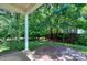 Backyard view with stone patio at 204 Southern Style Dr, Holly Springs, NC 27540