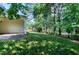 Spacious backyard with lush lawn and mature trees at 204 Southern Style Dr, Holly Springs, NC 27540