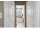 Bathroom with tub and tiled floor seen through open closet doors at 204 Southern Style Dr, Holly Springs, NC 27540