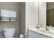 Neutral half bathroom featuring a toilet and single sink vanity with a mirror and lighting at 204 Southern Style Dr, Holly Springs, NC 27540