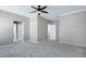 Large bedroom featuring neutral carpet, ceiling fan, and doorway to closet at 204 Southern Style Dr, Holly Springs, NC 27540