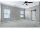 Bedroom featuring neutral carpet, ceiling fan and natural light from two windows at 204 Southern Style Dr, Holly Springs, NC 27540