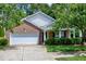 Cozy single-Gathering home with brick accents, vinyl siding, a two-car garage, and neat front yard at 204 Southern Style Dr, Holly Springs, NC 27540