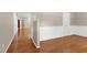 Beautiful living room featuring hardwood floors, white wainscoting, and neutral wall paint throughout at 204 Southern Style Dr, Holly Springs, NC 27540