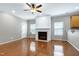 Cozy living room featuring a classic fireplace, ceiling fan, and natural light at 204 Southern Style Dr, Holly Springs, NC 27540