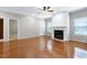Bright living room with hardwood floors, a fireplace, and a ceiling fan at 204 Southern Style Dr, Holly Springs, NC 27540