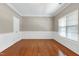 Elegant living room featuring hardwood floors, wainscoting details, crown molding, and ample natural light at 204 Southern Style Dr, Holly Springs, NC 27540