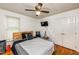 Bedroom with ceiling fan, wooden headboard, and hardwood floors, providing a modern aesthetic at 210 Dutchess Dr, Cary, NC 27513