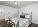Cozy bedroom with a white closet, decorative pillows, and a metal-framed bed at 210 Dutchess Dr, Cary, NC 27513