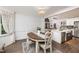 Open dining area flows into a bright kitchen featuring an island and white cabinets at 210 Dutchess Dr, Cary, NC 27513