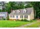 Traditional home with a blue front door and lush landscaping at 210 Dutchess Dr, Cary, NC 27513