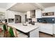 Modern kitchen with white cabinets, stainless steel appliances, and a large island with seating at 210 Dutchess Dr, Cary, NC 27513