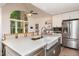 Bright kitchen with a large island, stainless steel appliances, and a view of the backyard at 210 Dutchess Dr, Cary, NC 27513