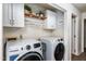 Bright laundry room with modern appliances, white cabinets, and ample storage space at 210 Dutchess Dr, Cary, NC 27513