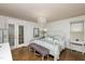 Inviting main bedroom with hardwood floors, chandelier lighting, and a door leading to the outdoors at 210 Dutchess Dr, Cary, NC 27513