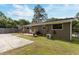 Backyard featuring patio, grill, mature trees, and partial grass at 2125 Cheek Rd, Durham, NC 27704