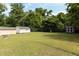 Spacious backyard featuring storage sheds, firepit, and recreational disc golf basket, perfect for outdoor activities and storage at 2125 Cheek Rd, Durham, NC 27704