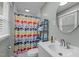 Bathroom with a bright patterned shower curtain, large mirror, and stylish design at 2125 Cheek Rd, Durham, NC 27704
