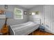 Bright bedroom featuring natural light, hardwood floors, and calming neutral paint tones at 2125 Cheek Rd, Durham, NC 27704