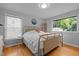 Bedroom with hardwood floors, large windows, a comfortable bed, and neutral wall color at 2125 Cheek Rd, Durham, NC 27704