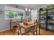 Bright dining area featuring hardwood floors, a wooden table with chairs, and natural light at 2125 Cheek Rd, Durham, NC 27704
