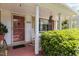 Charming front porch featuring hanging flower baskets, a rocking chair, and the house number 2125 at 2125 Cheek Rd, Durham, NC 27704