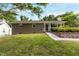 Ranch-style home featuring a covered front porch and mature landscaping on a sunny day at 2125 Cheek Rd, Durham, NC 27704