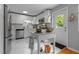 Bright white kitchen with a door, white cabinets, marble countertops, and a marble floor at 2125 Cheek Rd, Durham, NC 27704