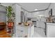 Bright kitchen featuring white cabinets, stainless steel appliances, and marble floors at 2125 Cheek Rd, Durham, NC 27704