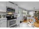 Spacious kitchen with stainless steel appliances, white cabinets and marble floor at 2125 Cheek Rd, Durham, NC 27704