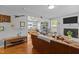 Open-concept living room with hardwood floors, a fireplace, and views into the dining area at 2125 Cheek Rd, Durham, NC 27704