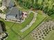 Aerial view of a beautifully landscaped backyard with a stream and patio at 213 Lofty Oak Ln, Holly Springs, NC 27540