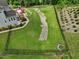 A backyard featuring a stream, hot tub, outdoor seating, and lush landscaping at 213 Lofty Oak Ln, Holly Springs, NC 27540