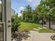 Beautifully landscaped backyard with a well-maintained lawn, stone pathway and black metal fence at 213 Lofty Oak Ln, Holly Springs, NC 27540
