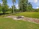 Well-manicured backyard featuring a small bridge over a rock lined stream at 213 Lofty Oak Ln, Holly Springs, NC 27540