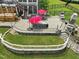 Expansive backyard featuring a patio, outdoor kitchen, dining area, and lush landscaping at 213 Lofty Oak Ln, Holly Springs, NC 27540