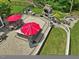Aerial view of the backyard featuring a patio, outdoor kitchen, fireplace, and landscaped areas at 213 Lofty Oak Ln, Holly Springs, NC 27540